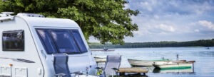 Adult Only Caravan Parks UK Caravan by serene lakeside setting.