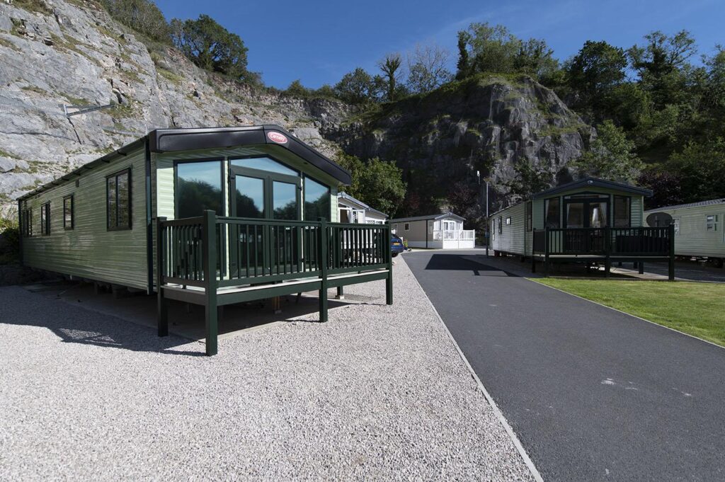 Scout Cragg holiday park caravan infront of cliff face