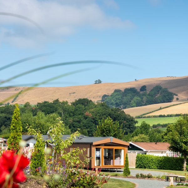 Scenic countryside with holiday lodges.