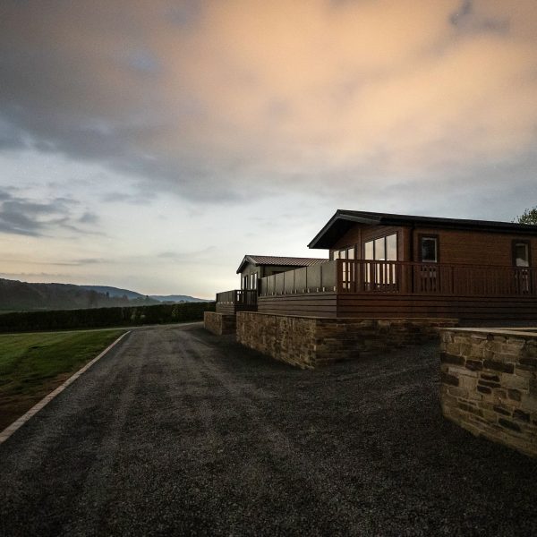 Lodges at dusk with cloudy sky