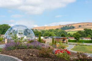 Geodesic dome in scenic countryside setting.